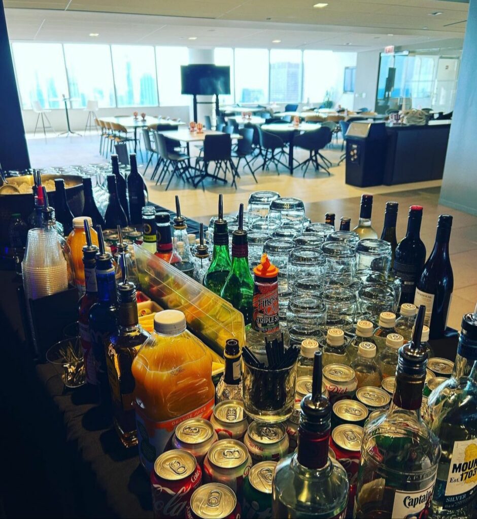 A well-organized bartending set-up with bottles, glassware, and tools in Wilmette, ready for a lively event.